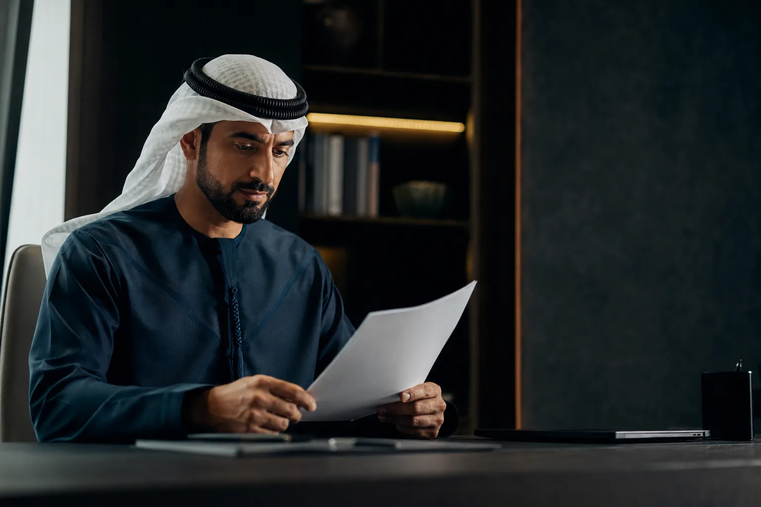 A professional reviewing a governance document at an uncluttered desk
