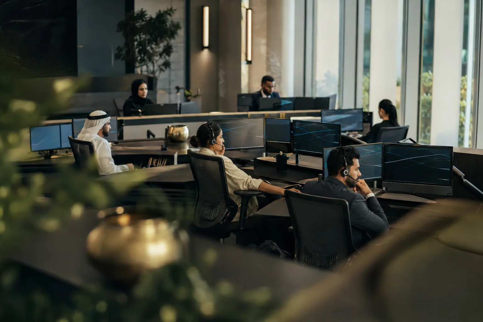 A modern Gulf operations floor with professionals at work in natural light