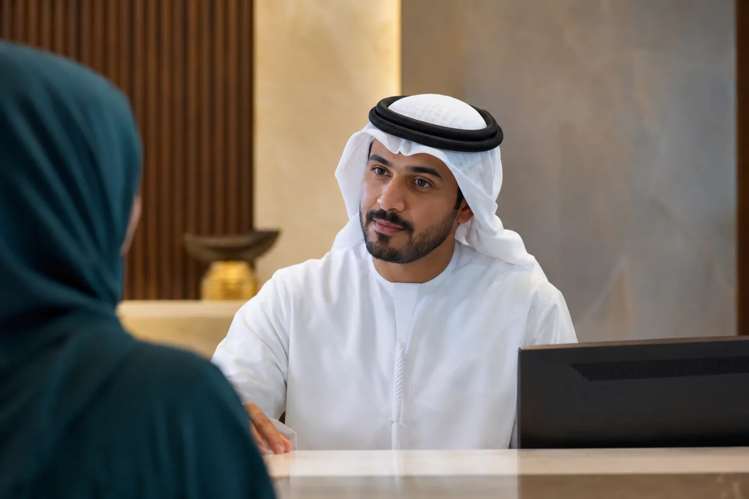 An Arabic-first service professional assisting attentively